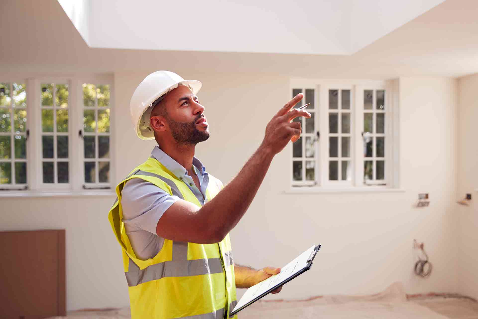 Third Party Wall Surveyors Bradford reviewing plans between two parties during a dispute